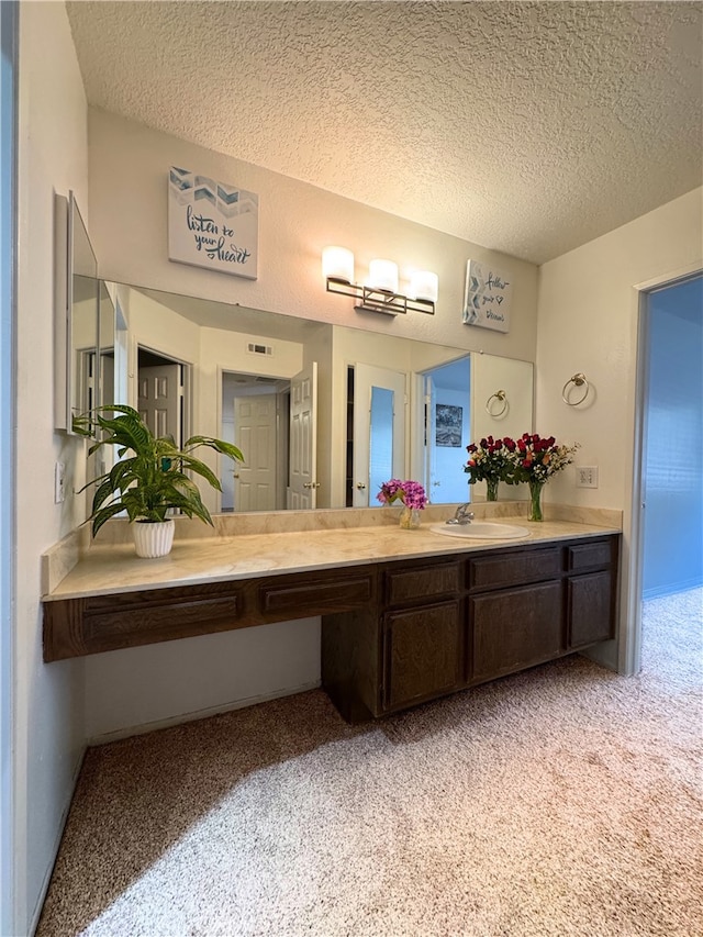1480 W Edgehill Rd Unit 58, San Bernardino, CA 92405 - bathroom with a textured ceiling, carpet flooring, and vanity