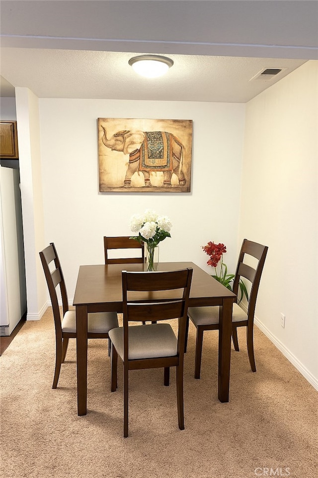 1480 W Edgehill Rd Unit 58, San Bernardino, CA 92405 - dining space with light carpet and baseboards