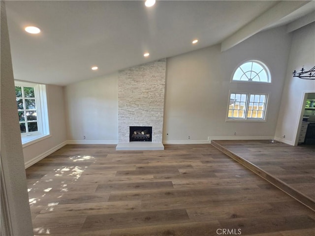 10281 Kings St, Los Alamitos, CA 90720 - unfurnished living room featuring healthy amount of natural light, wood finished floors, a fireplace, recessed lighting, and high vaulted ceiling