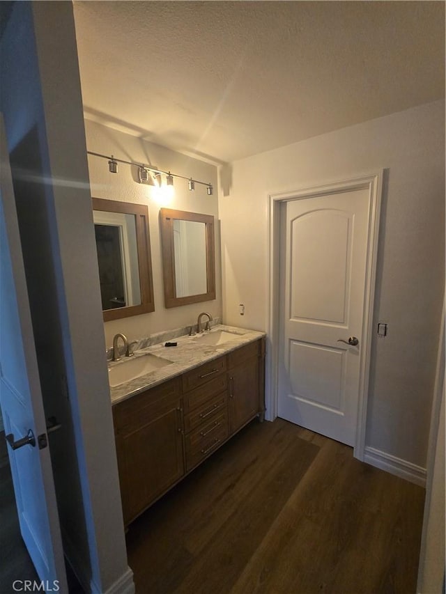 10281 Kings St, Los Alamitos, CA 90720 - full bathroom featuring wood finished floors and double vanity