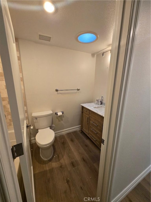 10281 Kings St, Los Alamitos, CA 90720 - bathroom featuring wood finished floors, vanity, and a textured ceiling