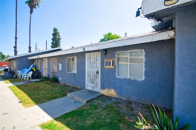 188 E 11th St Unit 1-4, San Bernardino, CA 92410 - view of front facade with stucco siding and a front lawn
