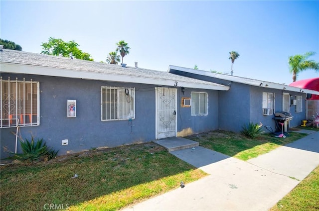 188 E 11th St Unit 1-4, San Bernardino, CA 92410 - view of front of home with stucco siding and a front lawn