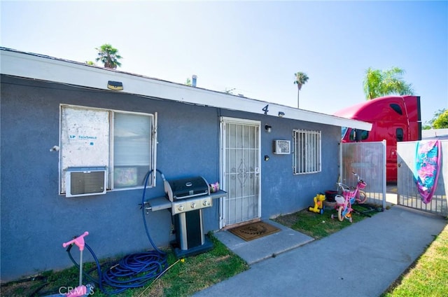 188 E 11th St Unit 1-4, San Bernardino, CA 92410 - doorway to property with stucco siding and cooling unit