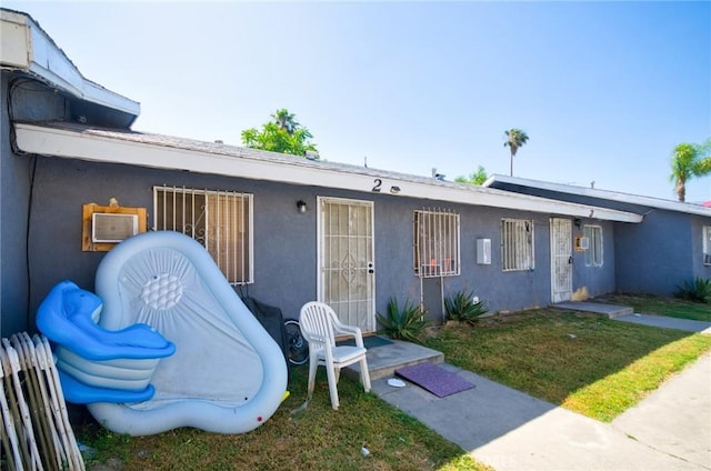 188 E 11th St Unit 1-4, San Bernardino, CA 92410 - view of front facade featuring stucco siding and a front lawn