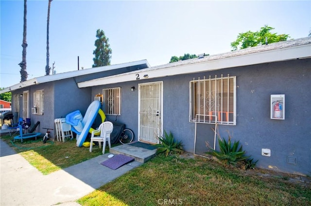 188 E 11th St Unit 1-4, San Bernardino, CA 92410 - bungalow-style home featuring stucco siding and a front lawn