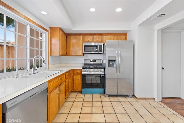 10519 La Rosa Cir, Fountain Valley, CA 92708 - kitchen with appliances with stainless steel finishes, brown cabinets, light countertops, and recessed lighting