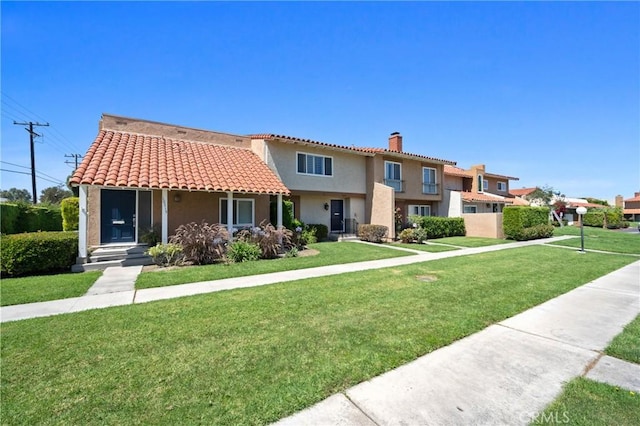 10519 La Rosa Cir, Fountain Valley, CA 92708 - view of front of home with a chimney, stucco siding, a tile roof, and a front yard