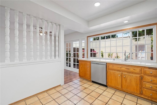 10519 La Rosa Cir, Fountain Valley, CA 92708 - kitchen with stainless steel dishwasher, brown cabinetry, light countertops, recessed lighting, and light tile patterned flooring