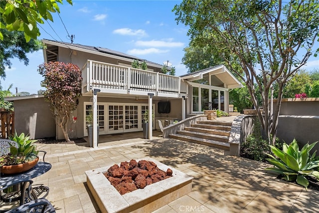 11212 Brunswick Way N, Tustin, CA 92705 - back of house with a fire pit, a patio area, stucco siding, french doors, and a deck