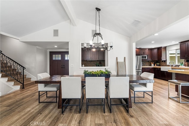 11212 Brunswick Way N, Tustin, CA 92705 - dining room with stairs, light wood finished floors, a chandelier, beamed ceiling, and recessed lighting