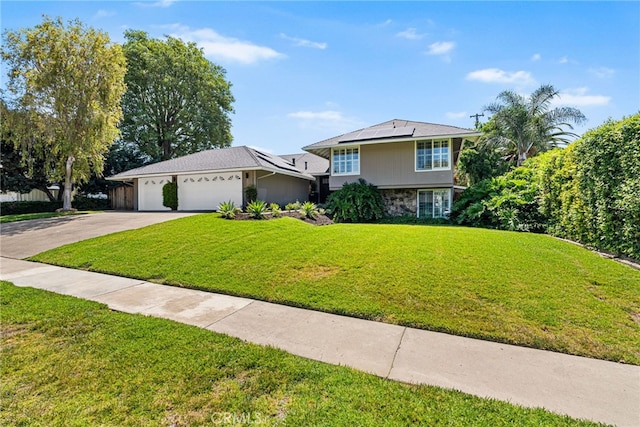 11212 Brunswick Way N, Tustin, CA 92705 - view of front facade with solar panels, driveway, an attached garage, stone siding, and a front yard