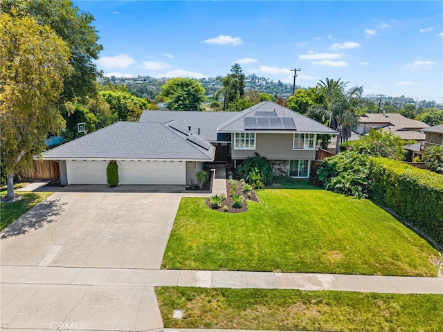 11212 Brunswick Way N, Tustin, CA 92705 - view of front of home featuring an attached garage, roof mounted solar panels, concrete driveway, and stone siding