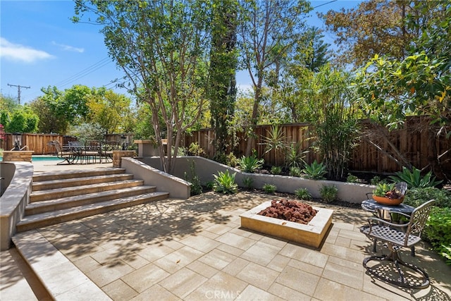 11212 Brunswick Way N, Tustin, CA 92705 - fenced backyard with a patio and an outdoor fire pit