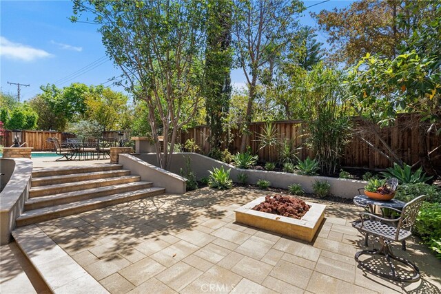 11212 Brunswick Way N, Tustin, CA 92705 - fenced backyard with a patio and an outdoor fire pit