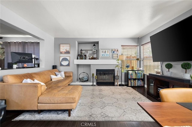 943 Miraflores Dr, Corona, CA 92882 - living area featuring a glass covered fireplace and wood finished floors