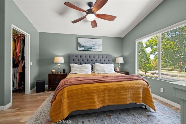 943 Miraflores Dr, Corona, CA 92882 - bedroom featuring lofted ceiling, a walk in closet, light wood finished floors, a ceiling fan, and a closet