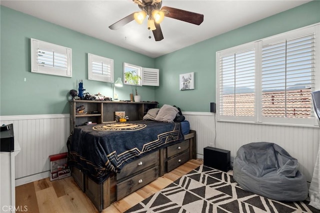 943 Miraflores Dr, Corona, CA 92882 - bedroom featuring wainscoting, wood finished floors, and ceiling fan