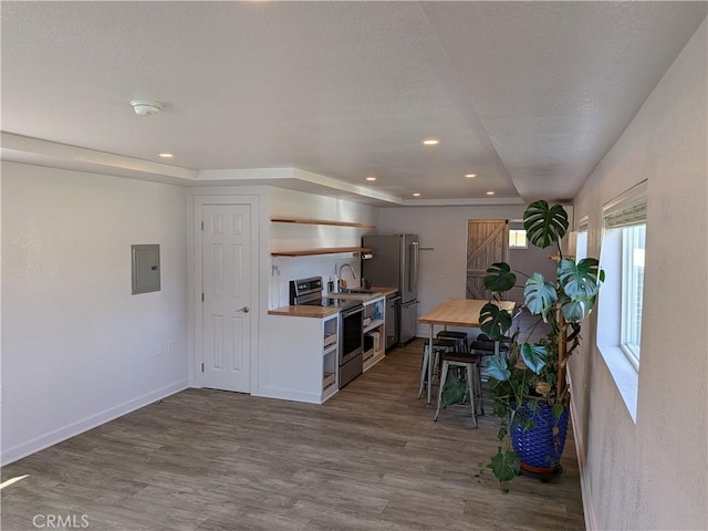 4020 F St, Eureka, CA 95503 - kitchen featuring appliances with stainless steel finishes, open shelves, dark wood-type flooring, electric panel, and recessed lighting