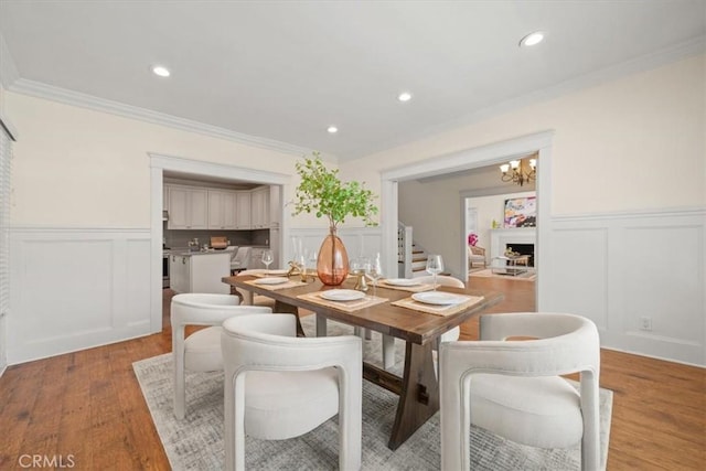 268 S Norton Ave, Los Angeles, CA 90004 - dining room with a decorative wall, wainscoting, a chandelier, light wood-style flooring, and ornamental molding