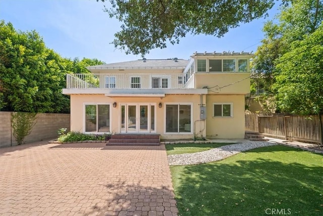 268 S Norton Ave, Los Angeles, CA 90004 - back of property featuring stucco siding, a fenced backyard, french doors, and entry steps