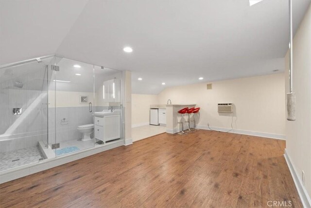 268 S Norton Ave, Los Angeles, CA 90004 - bathroom featuring lofted ceiling, a shower stall, wood finished floors, an AC wall unit, and recessed lighting