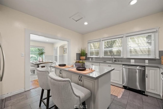 268 S Norton Ave, Los Angeles, CA 90004 - kitchen with dishwasher, white cabinets, a center island, tile patterned floors, and recessed lighting