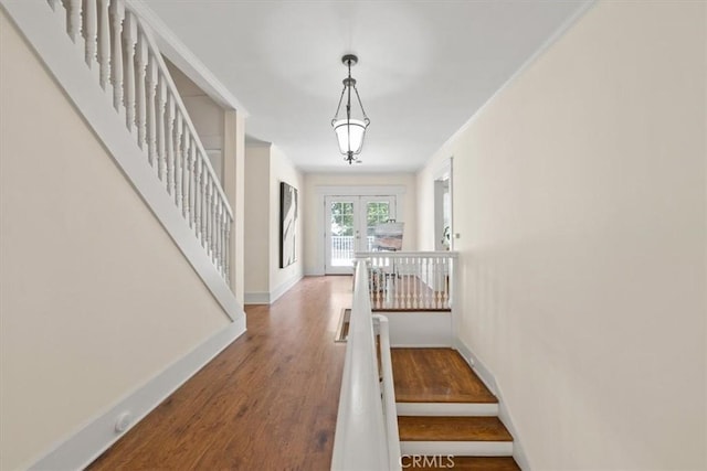 268 S Norton Ave, Los Angeles, CA 90004 - staircase with french doors, wood finished floors, and ornamental molding