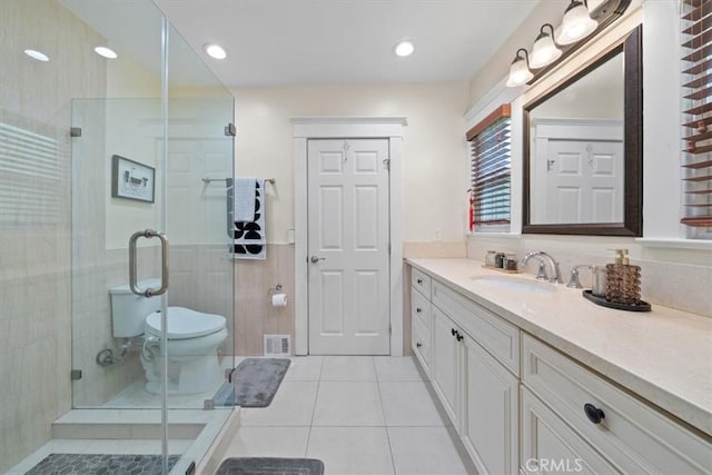268 S Norton Ave, Los Angeles, CA 90004 - bathroom with vanity, tile patterned flooring, a shower stall, and wainscoting