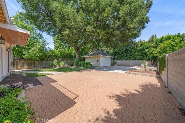 268 S Norton Ave, Los Angeles, CA 90004 - fenced backyard with an outbuilding, a patio, and a detached garage