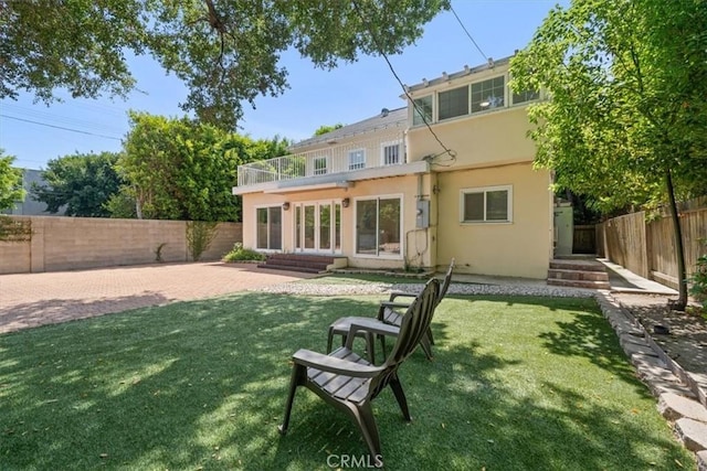 268 S Norton Ave, Los Angeles, CA 90004 - back of property with stucco siding, a fenced backyard, a patio, and entry steps