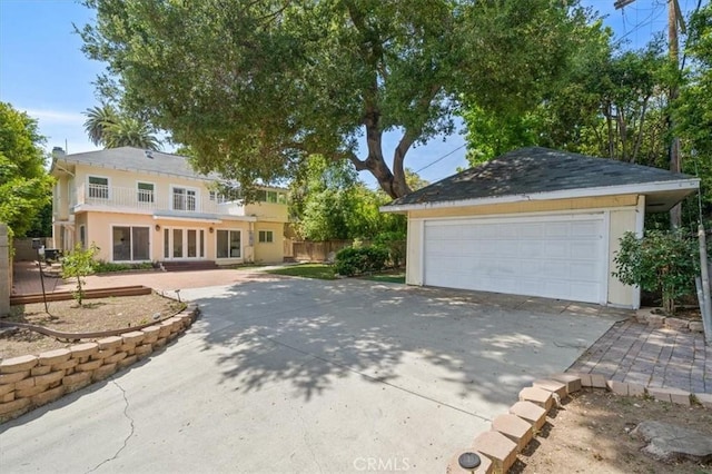 268 S Norton Ave, Los Angeles, CA 90004 - view of front facade with french doors, a garage, and stucco siding