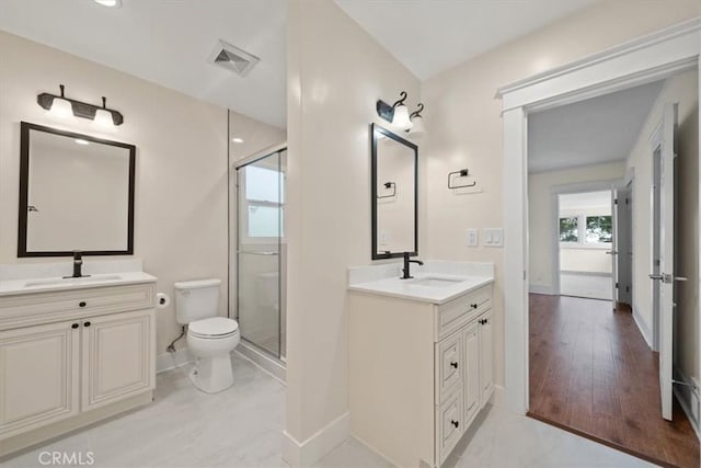 268 S Norton Ave, Los Angeles, CA 90004 - bathroom featuring a stall shower, two vanities, and wood finished floors