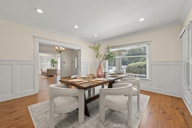 268 S Norton Ave, Los Angeles, CA 90004 - dining room with a decorative wall, wainscoting, crown molding, a chandelier, and light wood-style flooring