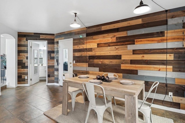 1837 Avenida Sevilla, Oceanside, CA 92056 - dining area with wooden walls, arched walkways, and dark tile patterned flooring