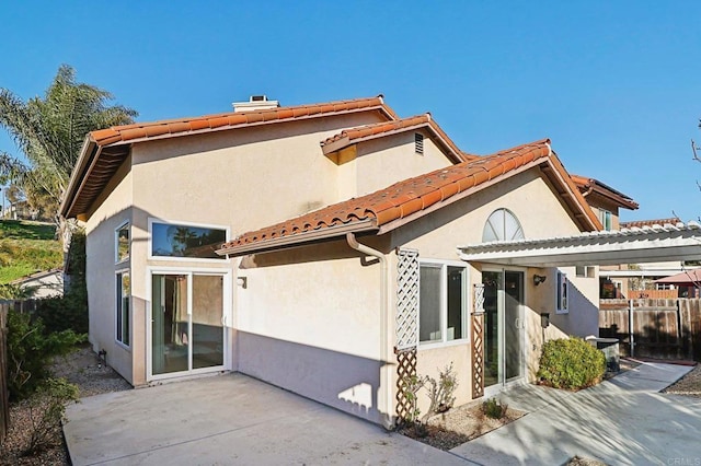 1837 Avenida Sevilla, Oceanside, CA 92056 - back of house with stucco siding, a patio, a tiled roof, and a chimney