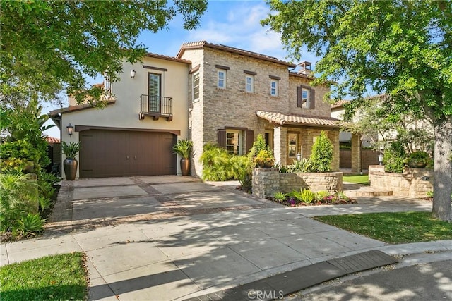 7 Kent Ct, Ladera Ranch, CA 92694 - mediterranean / spanish-style home with a balcony, stone siding, an attached garage, stucco siding, and concrete driveway