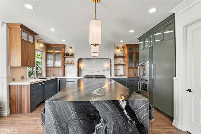 7 Kent Ct, Ladera Ranch, CA 92694 - kitchen with open shelves, tasteful backsplash, light wood-type flooring, recessed lighting, and appliances with stainless steel finishes