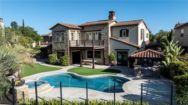 7 Kent Ct, Ladera Ranch, CA 92694 - back of property featuring a balcony, a tiled roof, a chimney, a gazebo, and stone siding