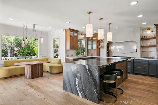 7 Kent Ct, Ladera Ranch, CA 92694 - kitchen featuring light wood-style flooring, gray cabinetry, glass insert cabinets, recessed lighting, and hanging light fixtures