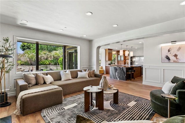 7 Kent Ct, Ladera Ranch, CA 92694 - living room with a decorative wall, light wood-type flooring, arched walkways, wainscoting, and recessed lighting
