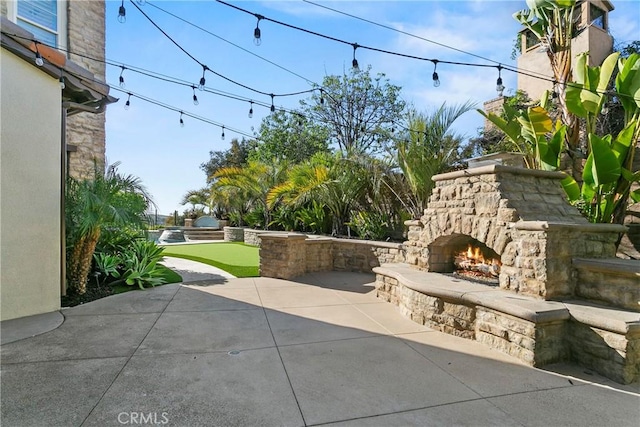 7 Kent Ct, Ladera Ranch, CA 92694 - view of patio featuring an outdoor stone fireplace and an area to practice putting