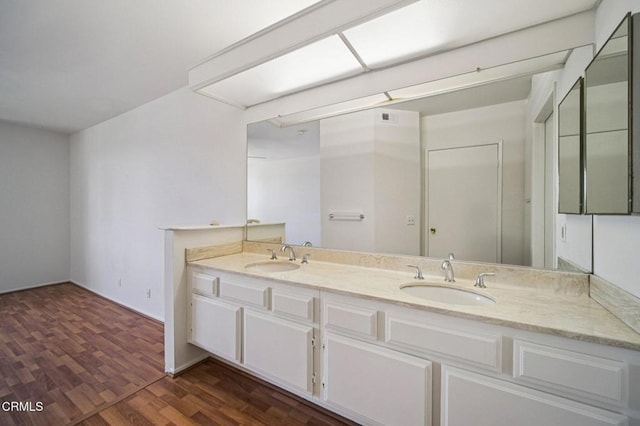 7211 Cozycroft Ave Unit 40, Winnetka, CA 91306 - bathroom featuring double vanity and wood finished floors