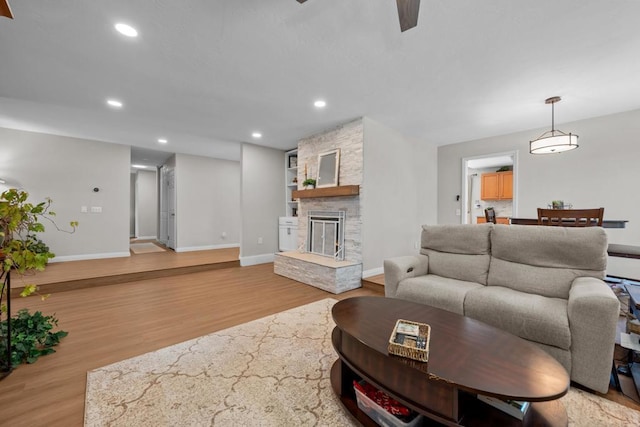 764 Barsby St, Vista, CA 92084 - living area with wood finished floors, recessed lighting, built in shelves, a stone fireplace, and a ceiling fan