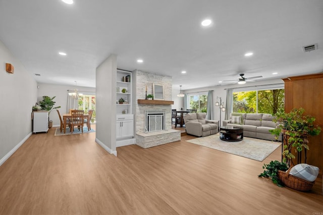764 Barsby St, Vista, CA 92084 - living area with light wood-style flooring, recessed lighting, ceiling fan, a fireplace, and a chandelier