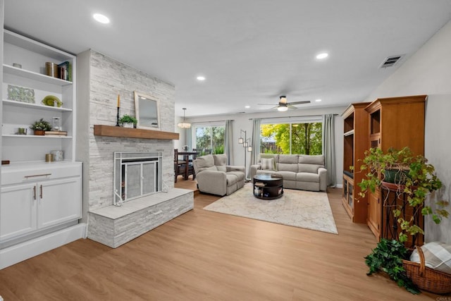 764 Barsby St, Vista, CA 92084 - living area featuring light wood-type flooring, a stone fireplace, a ceiling fan, and recessed lighting
