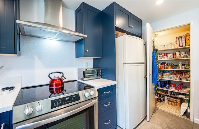 9739 Reseda Blvd Unit 36, Northridge, CA 91324 - kitchen featuring electric stove, freestanding refrigerator, wall chimney exhaust hood, blue cabinetry, and light countertops