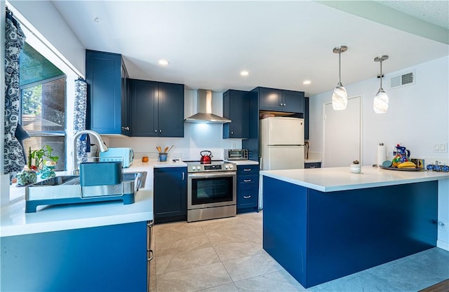 9739 Reseda Blvd Unit 36, Northridge, CA 91324 - kitchen with stainless steel electric range oven, wall chimney range hood, white fridge, blue cabinets, and a peninsula
