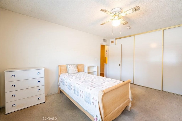 9739 Reseda Blvd Unit 36, Northridge, CA 91324 - bedroom with light colored carpet, a closet, a textured ceiling, and ceiling fan