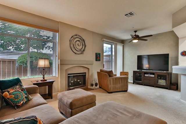 11368 Via Rancho San Diego Unit C, El Cajon, CA 92019 - living area featuring a ceiling fan, a glass covered fireplace, and carpet